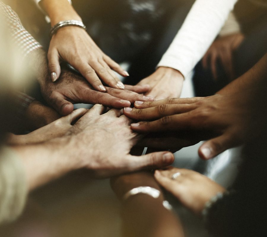 Closeup of diverse people joining their hands